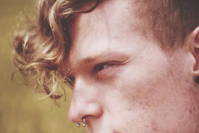 Close-up of young man with nose ring