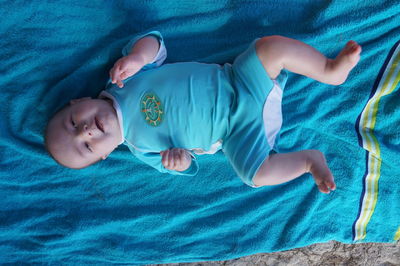 Portrait of baby resting on baby blanket