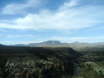 Scenic view of mountains against cloudy sky