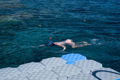 High angle view of man swimming in sea