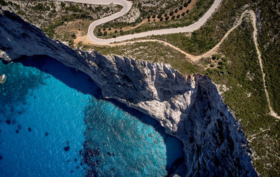 Aerial view of winding road by sea