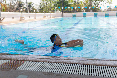 Boy swimming in pool