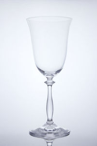 Close-up of wineglass against white background