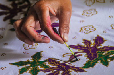 High angle view of person hand on table