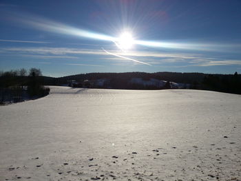Scenic view of landscape against sky during winter