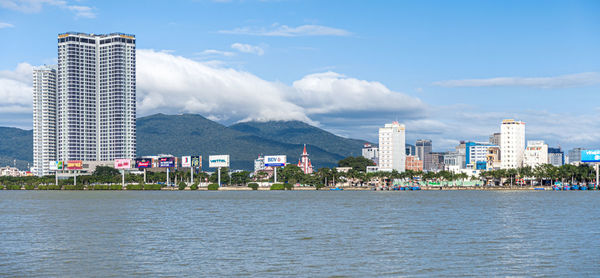 Panoramic view of sea and buildings against sky