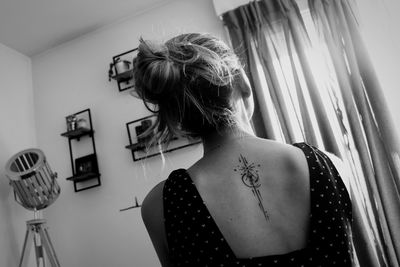 Rear view of woman looking at home