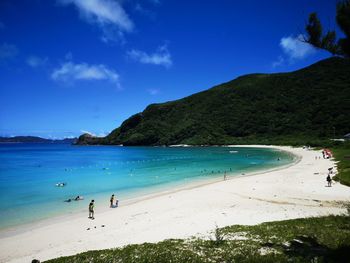 Scenic view of beach against blue sky