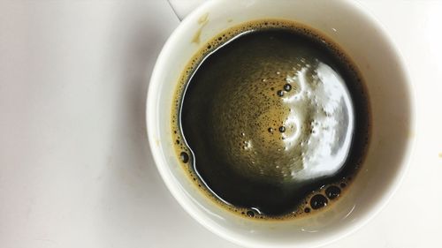 High angle view of coffee cup over black background