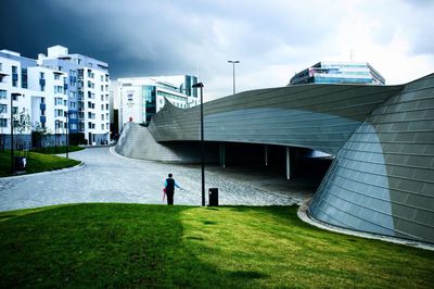 Man in front of building against sky