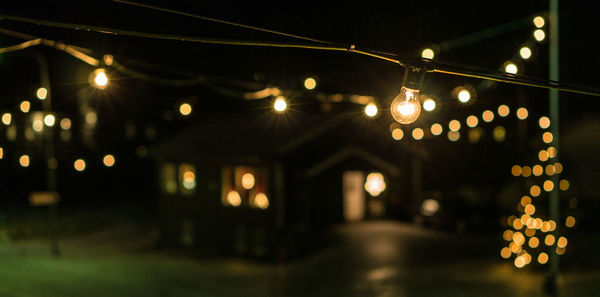 Defocused lights on illuminated street light at night