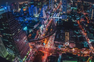 High angle view of city lit up at night