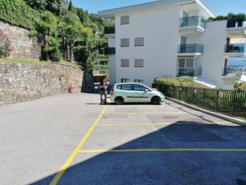 Cars on road by buildings in city