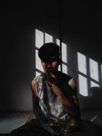 Young man sitting at home