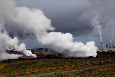 Geo thermal energy plant with smoke stacks and steam in iceland