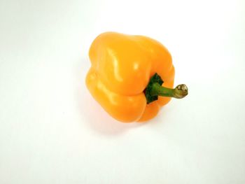 High angle view of yellow bell pepper against white background