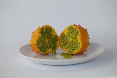 Close-up of orange slice in plate on table