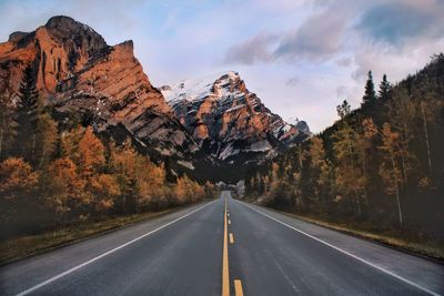 Road amidst mountains against sky