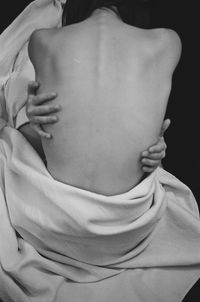 Nude art back of woman black background