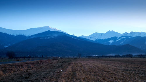 Scenic view of mountains against clear blue sky