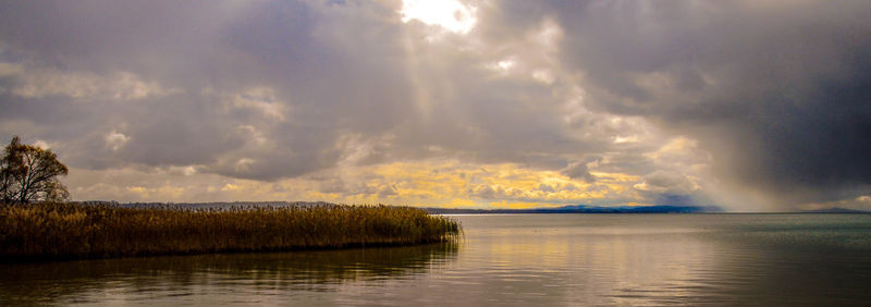 Scenic view of lake against sky during sunset