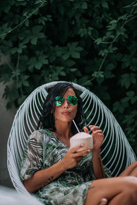 Portrait of woman holding mobile phone