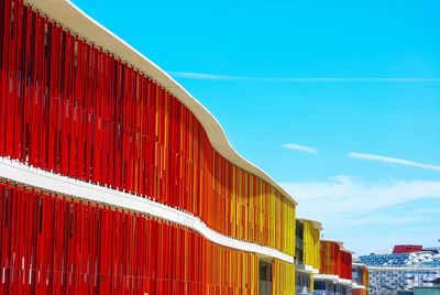 Low angle view of red building against blue sky