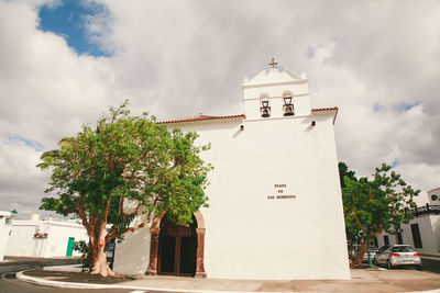 Low angle view of church against cloudy sky