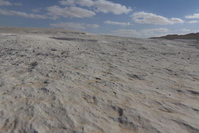 Surface level of barren land against sky