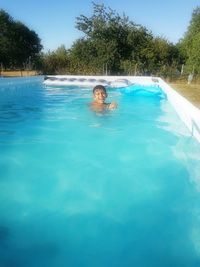 Young woman swimming in swimming pool