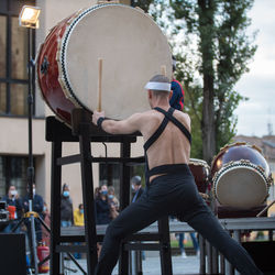 Rear view of man playing guitar