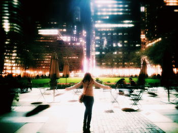 Blurred motion of woman in city at night