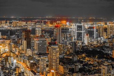 High angle view of illuminated buildings in city at night