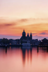 Reflection of buildings in city at sunset in amsterdam