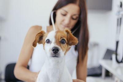 Female vet examining dog