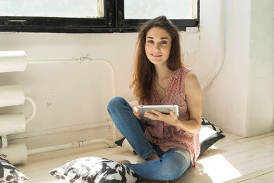 Portrait of young woman using smart phone