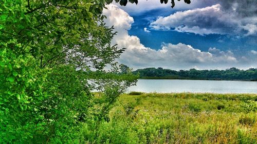 Scenic view of lake against cloudy sky