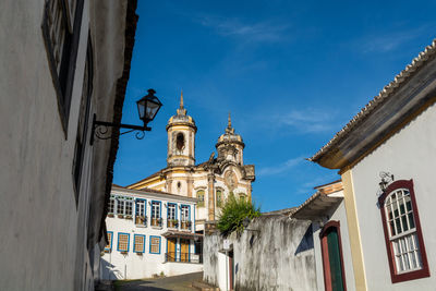 Low angle view of buildings against blue sky