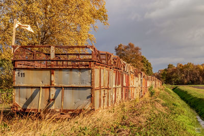 Abandoned built structure on field against sky