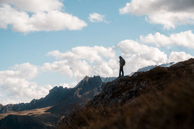 Person standing on top of a mountain in italy