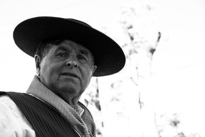 Portrait of man wearing hat standing outdoors