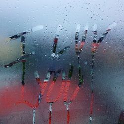 Road seen through wet glass window