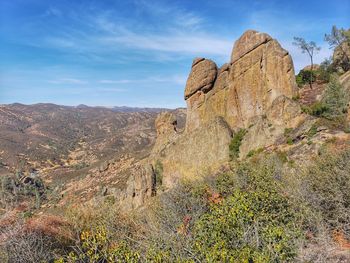 Rock formations on landscape against sky