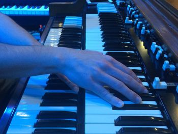 Close-up of man playing piano