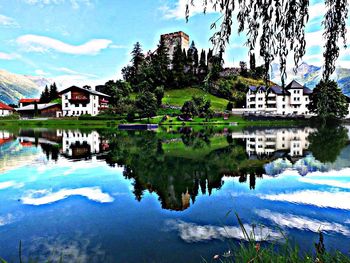 Calm lake with buildings in background