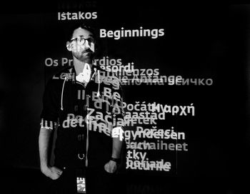 Low angle view of man standing on information sign