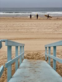 People on beach against sky