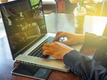 Low angle view of man using laptop on table