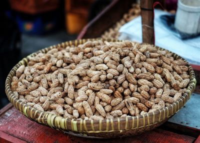 Close-up of peanuts in wicker basket for sale at market