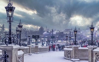 Street light and buildings against sky during winter